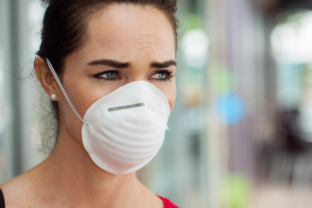 How Air Quality is Important Especially During a Pandemic 1 Close-up of a woman in the city wearing a face mask to protect herself from infection or air pollution.
