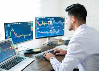 Young stock exchange trader working in office