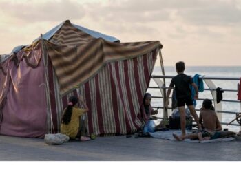 A displaced family, fleeing the Israeli airstrikes in the south, sits next to their tent on Beirut's corniche, Lebanon, Oct. 14, 2024.
