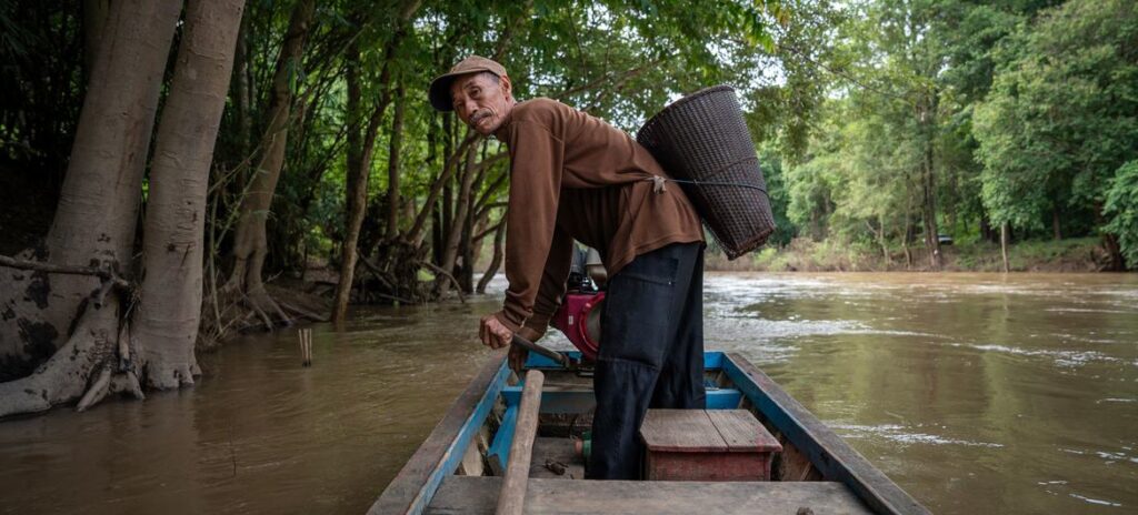 © UNU-EHS/Molly Ferrill A fisher navigates a passage through a forest in northern Thailand.
