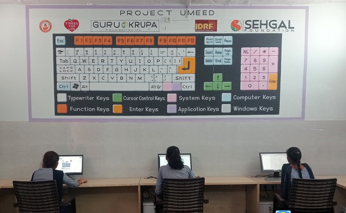 Students engaged in the Digital and Life Skills class learning hands-on computer skills